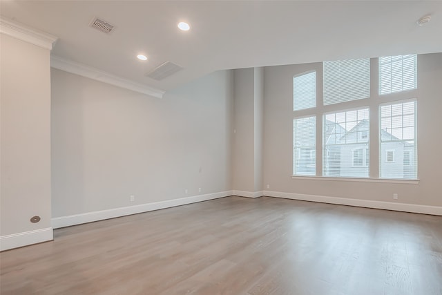 spare room with light hardwood / wood-style flooring and ornamental molding