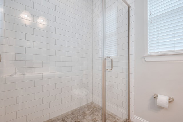 bathroom featuring a shower with shower door