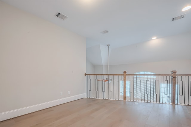 unfurnished room with light hardwood / wood-style flooring, ceiling fan, and vaulted ceiling