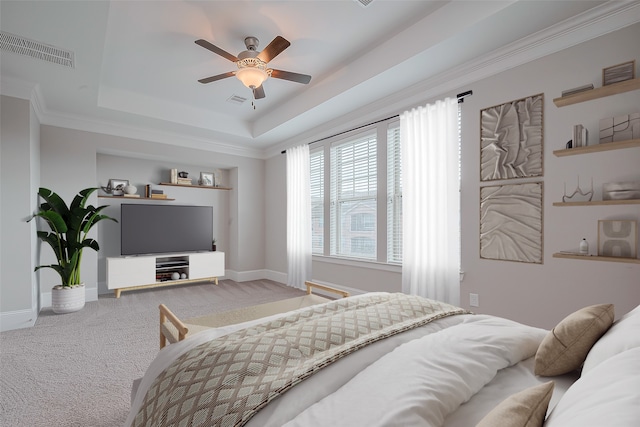 bedroom with ornamental molding, carpet floors, ceiling fan, and a raised ceiling