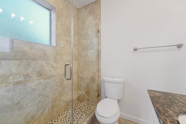 bathroom featuring vanity, toilet, and an enclosed shower