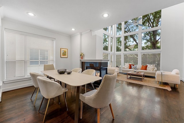 dining space featuring dark hardwood / wood-style floors and ornamental molding