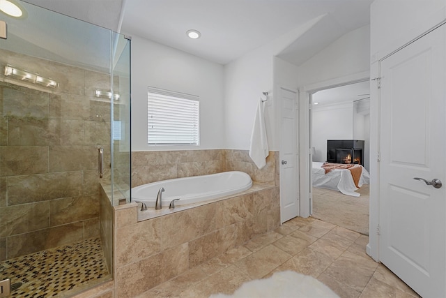 bathroom with independent shower and bath and vaulted ceiling