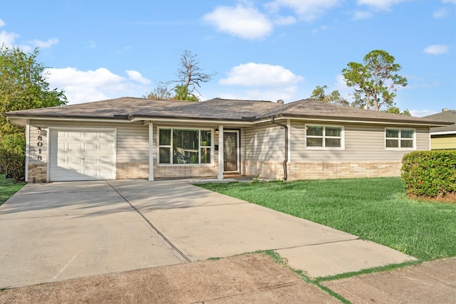 ranch-style house featuring a front lawn and a garage