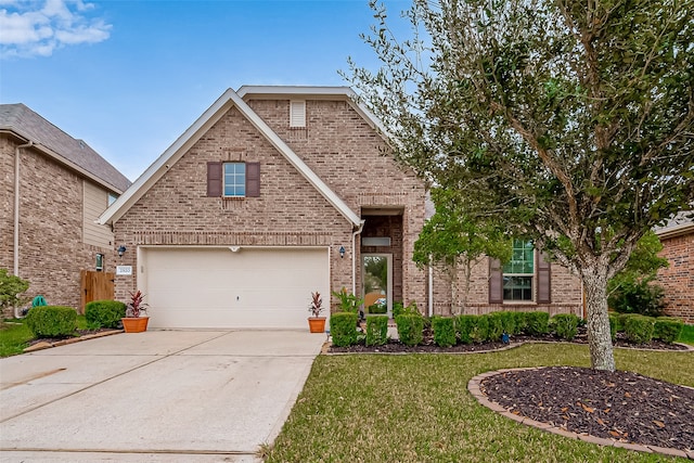 view of front of property featuring a front lawn and a garage