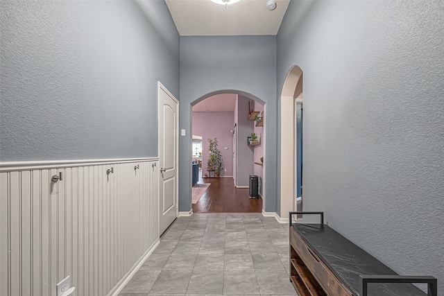 hall featuring light tile patterned floors