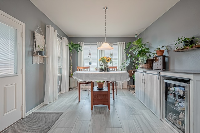 dining room featuring light wood-type flooring and beverage cooler