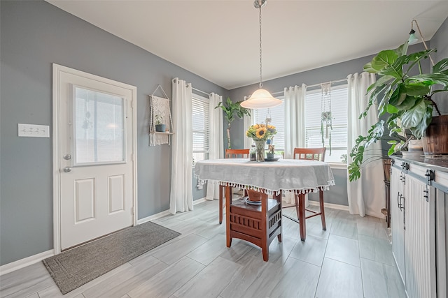 dining space with plenty of natural light and light hardwood / wood-style flooring