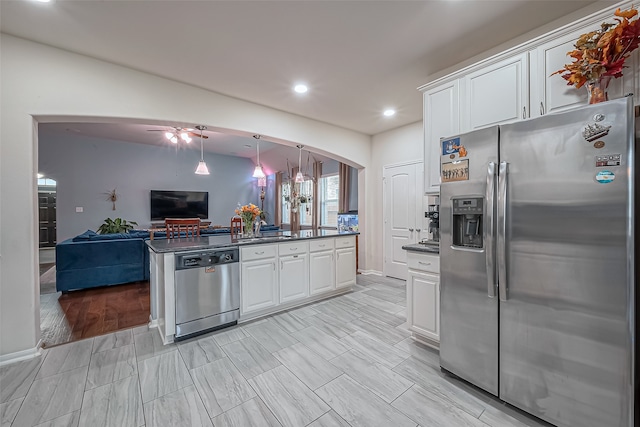 kitchen featuring stainless steel appliances, light wood-type flooring, hanging light fixtures, white cabinets, and ceiling fan