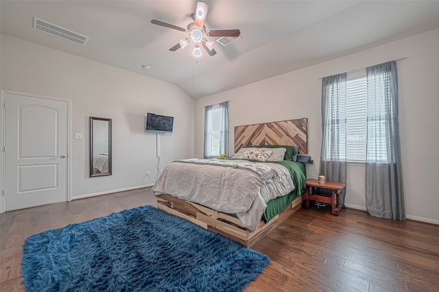 bedroom featuring dark hardwood / wood-style flooring, lofted ceiling, and ceiling fan