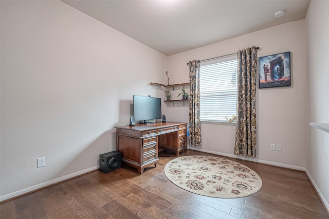 home office with wood-type flooring