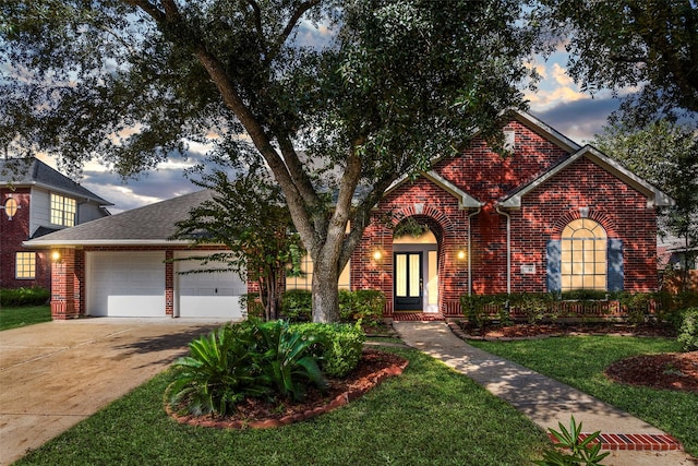 view of front of house featuring a yard and a garage