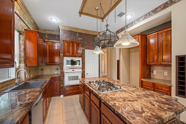 kitchen with decorative backsplash, sink, appliances with stainless steel finishes, and dark stone counters