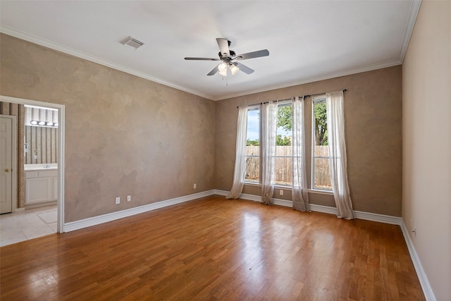 empty room featuring ceiling fan, light hardwood / wood-style flooring, and ornamental molding