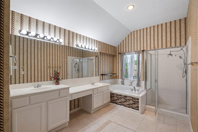 bathroom with tile patterned flooring, vanity, lofted ceiling, and independent shower and bath