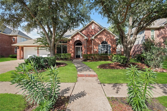 front of property with a garage and a front lawn