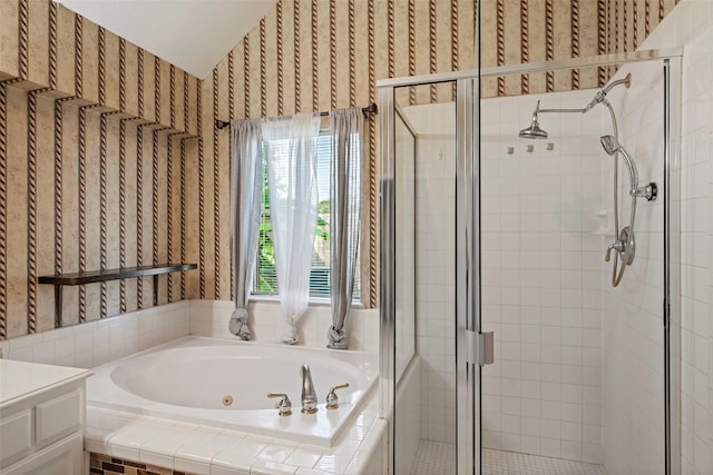 bathroom with separate shower and tub, vanity, and lofted ceiling