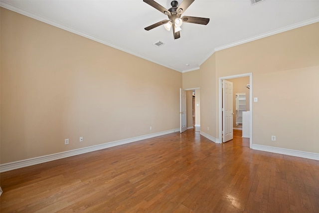 empty room featuring hardwood / wood-style flooring, ceiling fan, and ornamental molding