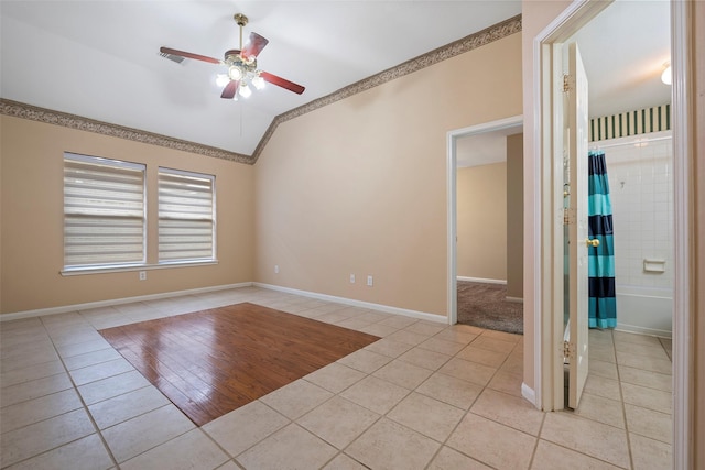 tiled spare room featuring ceiling fan