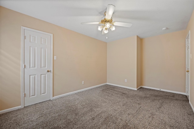 carpeted spare room with ceiling fan