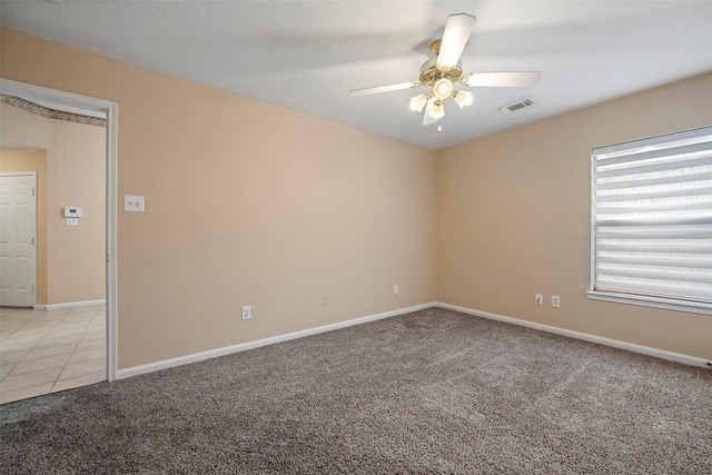 spare room featuring ceiling fan and light colored carpet