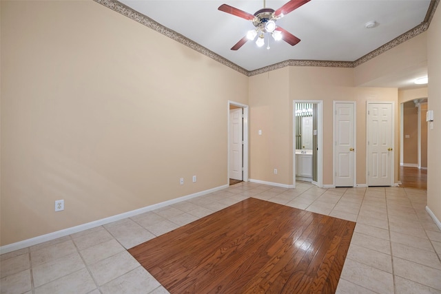 empty room featuring light tile patterned floors and ceiling fan