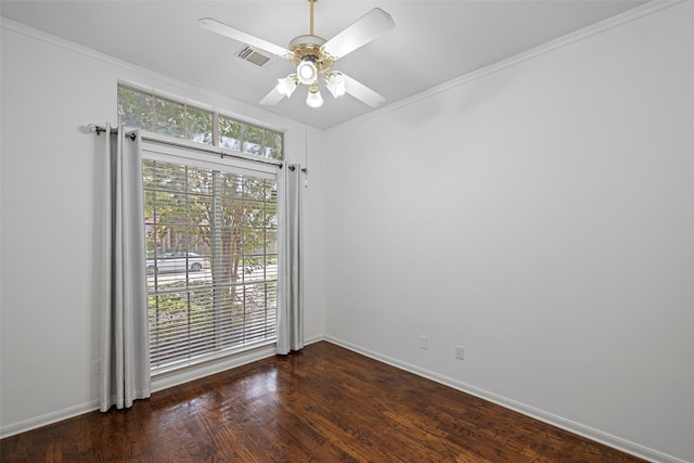 empty room with ceiling fan, dark hardwood / wood-style flooring, crown molding, and a wealth of natural light