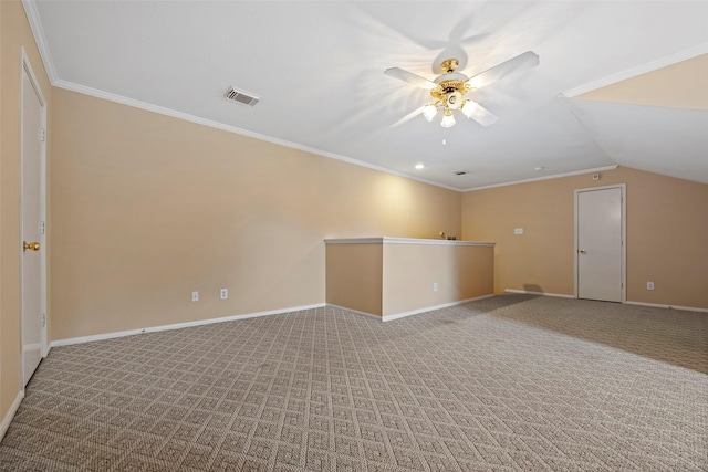 empty room featuring carpet flooring, ceiling fan, ornamental molding, and vaulted ceiling