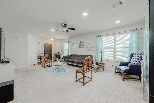 carpeted living room featuring ceiling fan