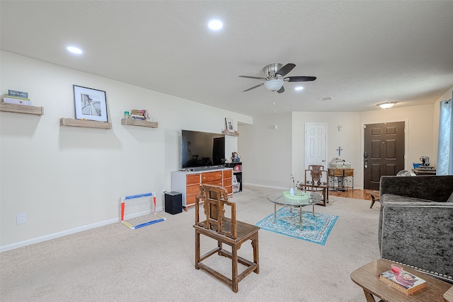 living room featuring light carpet and ceiling fan