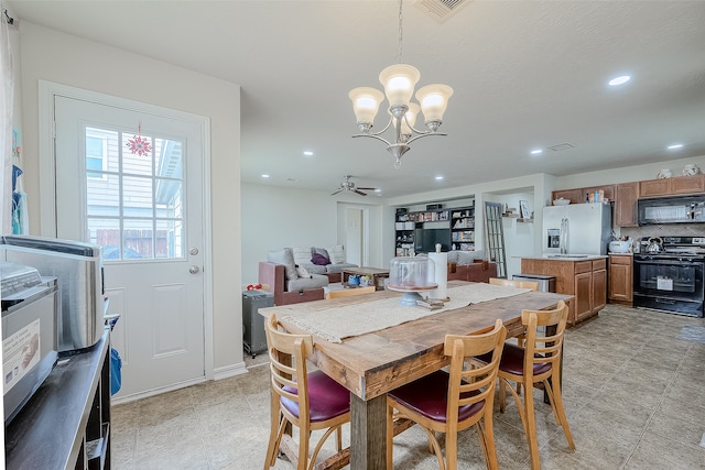 dining area featuring ceiling fan with notable chandelier