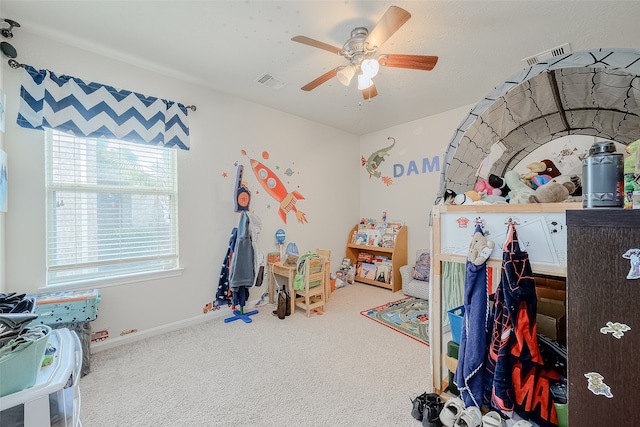 rec room with ceiling fan and carpet floors