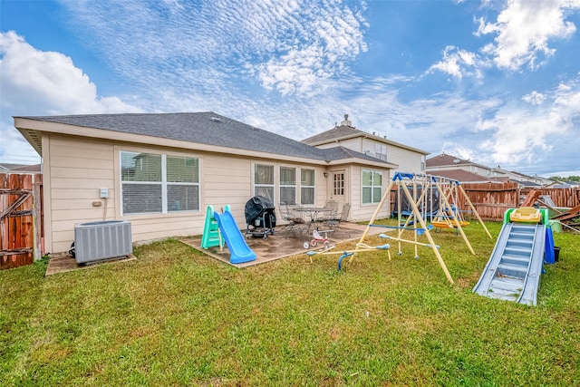 back of property featuring a patio, central AC unit, a playground, and a yard