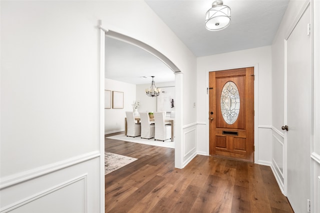 foyer featuring dark hardwood / wood-style floors, a textured ceiling, and a chandelier