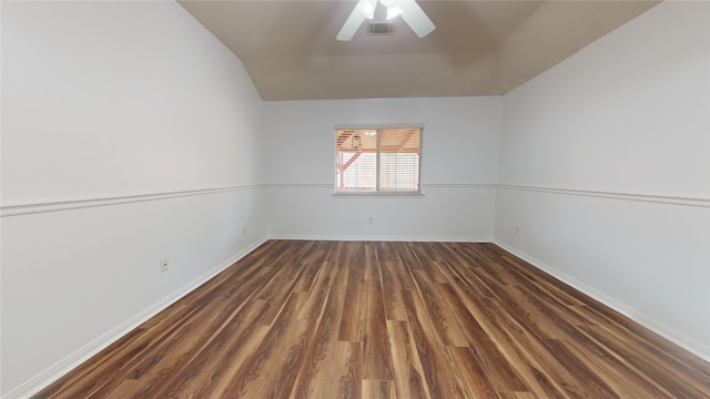 empty room featuring lofted ceiling, ceiling fan, and dark hardwood / wood-style floors