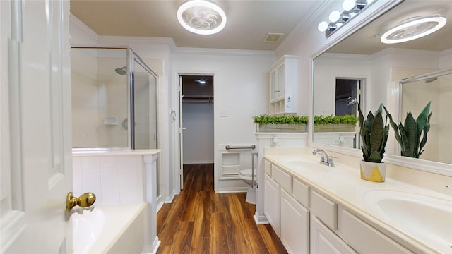 full bathroom with ornamental molding, vanity, hardwood / wood-style flooring, plus walk in shower, and toilet