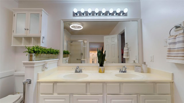 bathroom featuring vanity, toilet, and an enclosed shower