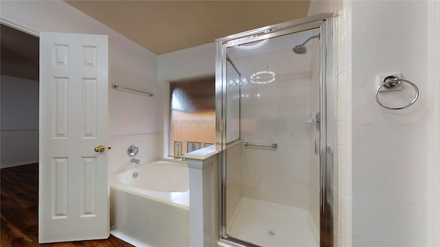 bathroom with hardwood / wood-style floors, separate shower and tub, and ornamental molding