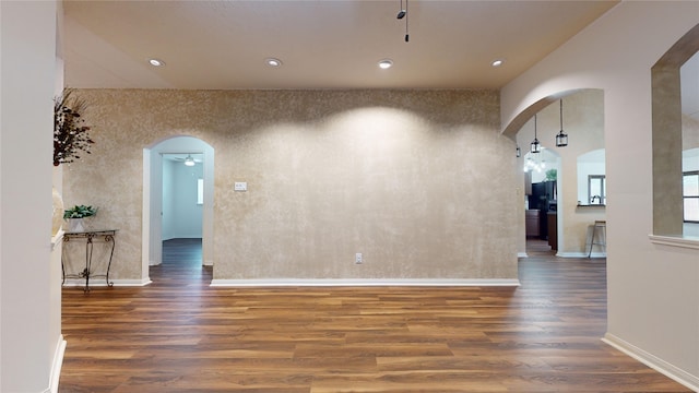 spare room featuring ceiling fan and dark hardwood / wood-style floors