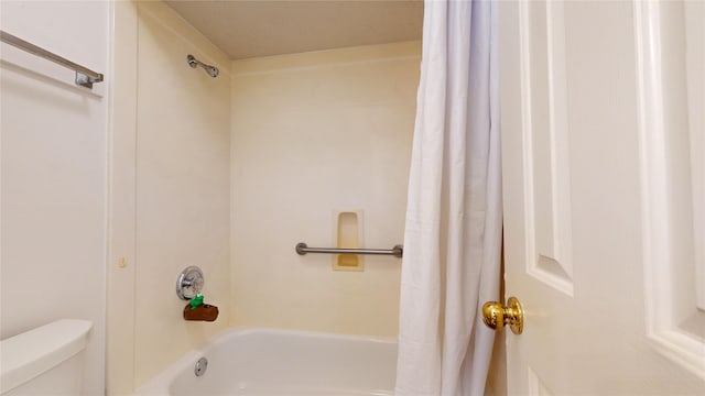 bathroom with shower / bathtub combination with curtain and toilet