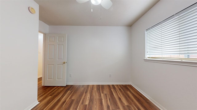 spare room featuring dark hardwood / wood-style floors and ceiling fan