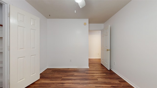 unfurnished bedroom featuring ceiling fan and dark wood-type flooring