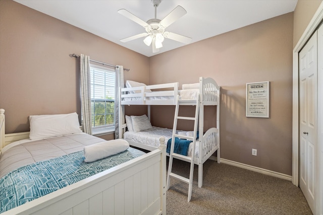 carpeted bedroom featuring ceiling fan and a closet