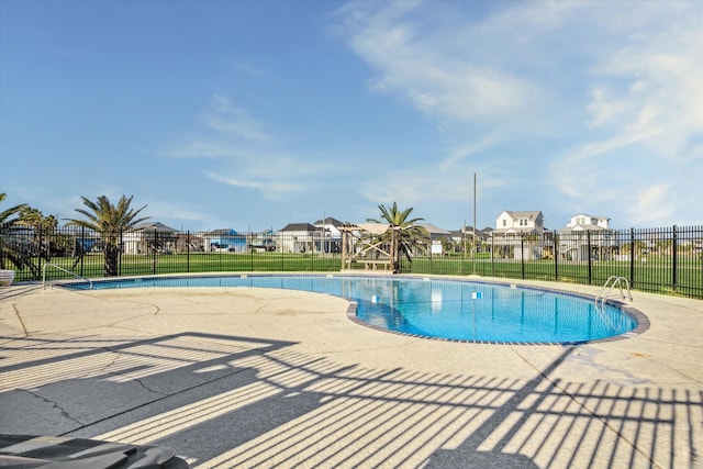 view of swimming pool featuring a lawn and a patio