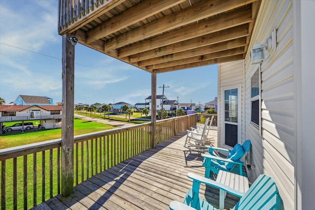 wooden deck featuring a yard