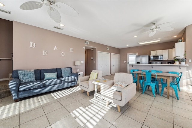 living room featuring ceiling fan and light tile patterned flooring