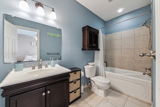 full bathroom with vanity, ceiling fan, tile patterned flooring, toilet, and tiled shower / bath