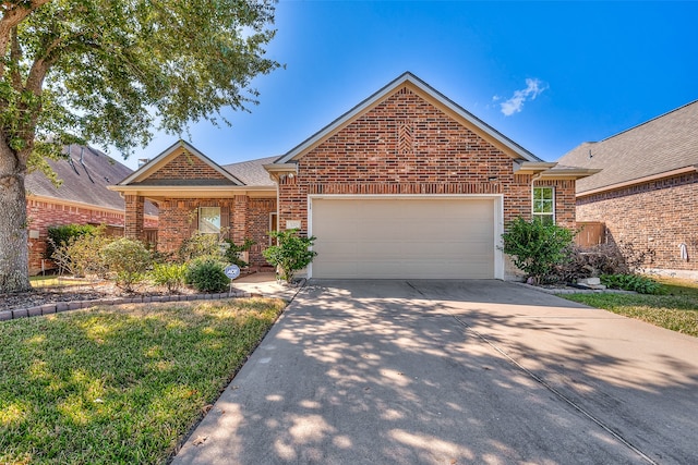 view of front of property featuring a garage and a front lawn