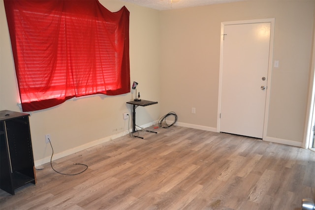 unfurnished room with hardwood / wood-style floors