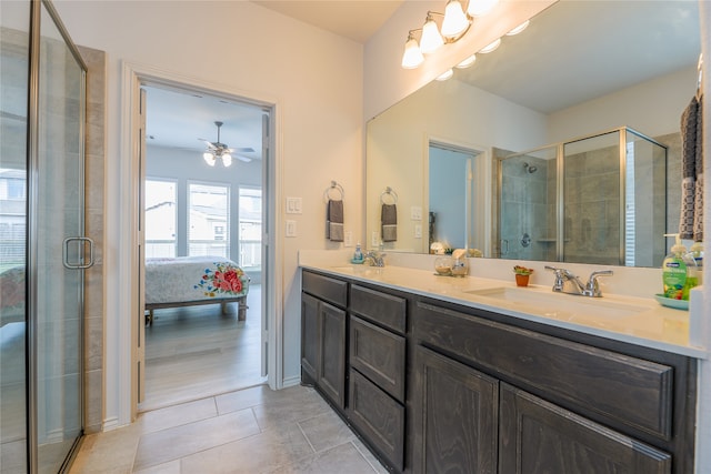 bathroom with tile patterned flooring, vanity, ceiling fan, and a shower with shower door